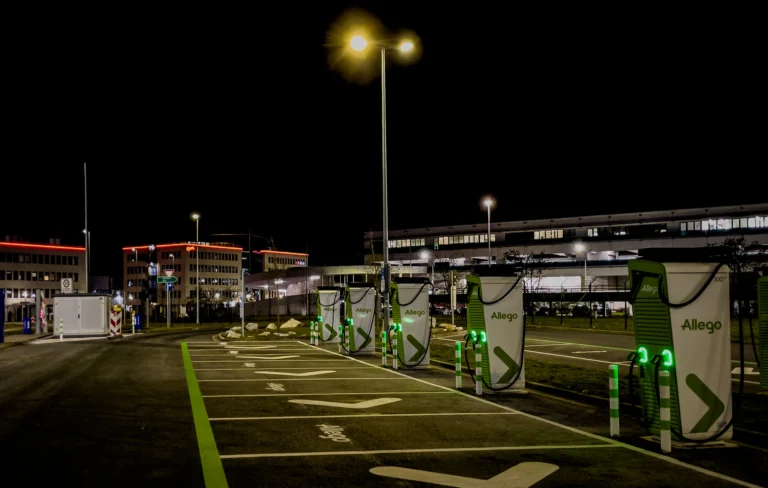 EV charging bays in a car park at night