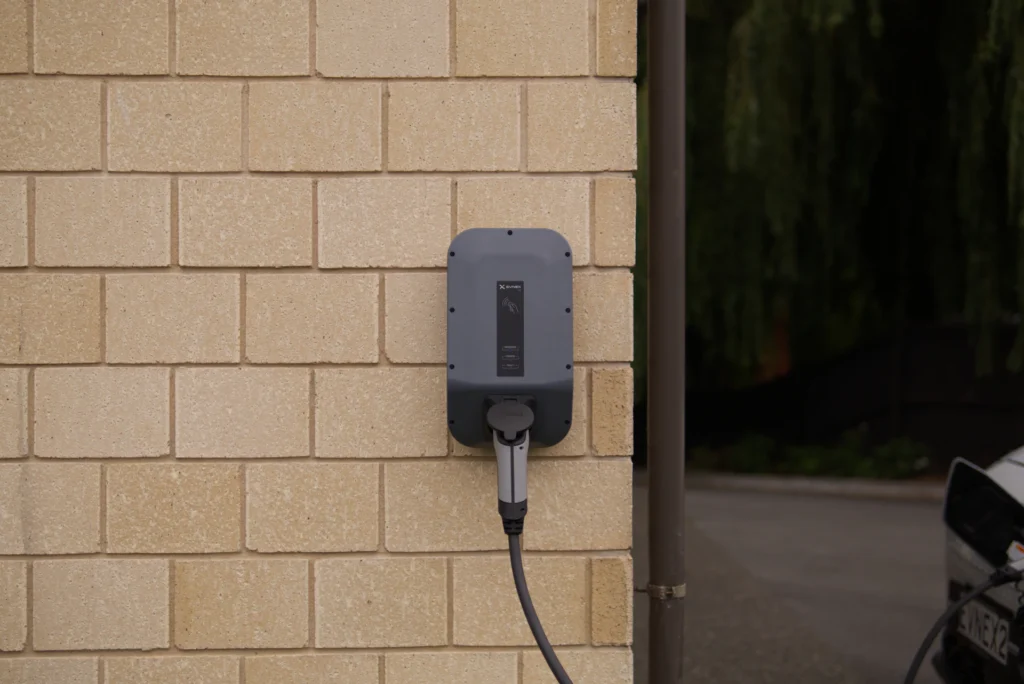 Wall-mounted EV charger with cable connected