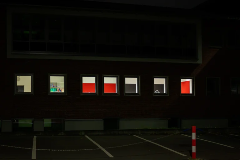 Office building exterior with lit windows at night